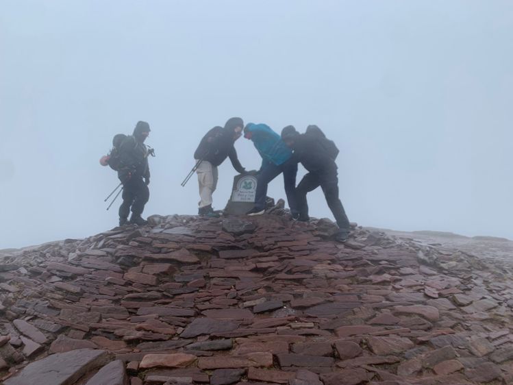 Group of walkers on mountain in bad weather