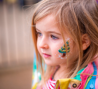 Little girl with Christmas tree face paint