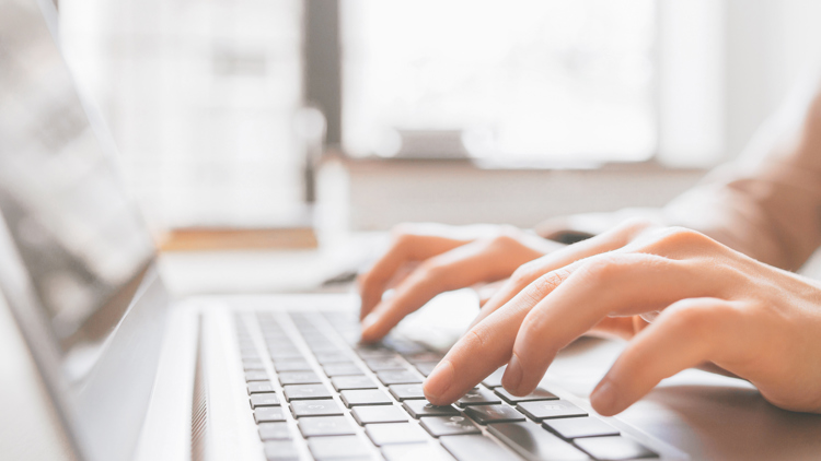 typing on a laptop computer