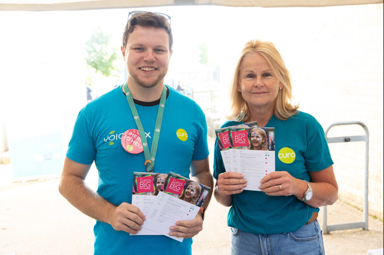 Sam Maggs and Claire Turner hand out programmes