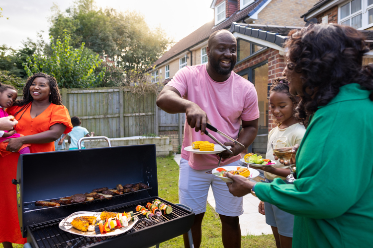 A family enjoying a barbecue int he garden