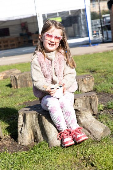 Little girl enjoys ice cream in the sun