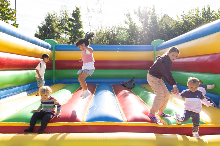 Resident children jump on bouncy castle