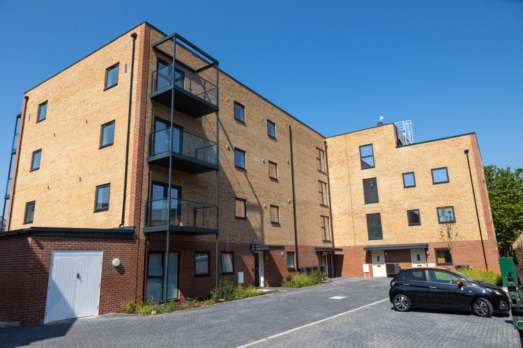 four storey L-shaped development in strong sunshine